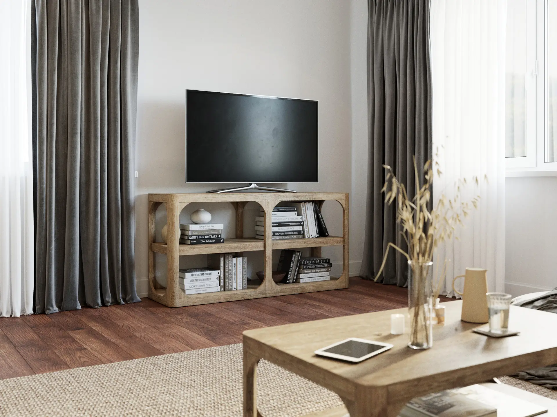 Residential living room with wood TV console, bookshelves, warm wood flooring, layered curtains and soft natural light.